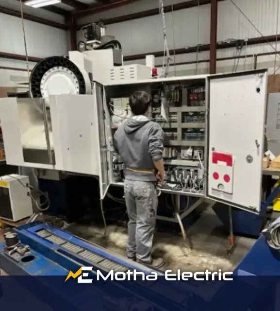 Motha Electrician working on commercial electrical service in Middlesex County, MA.