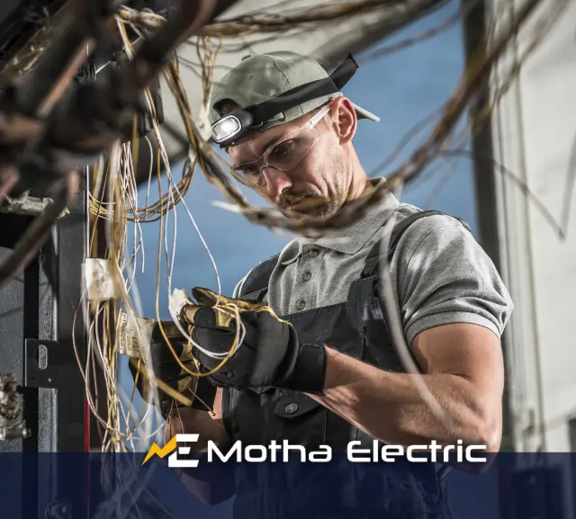 Electrician repairing a bunch of tangled wires.